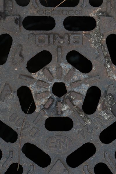 High angle shot of storm-drain in the middle of the street